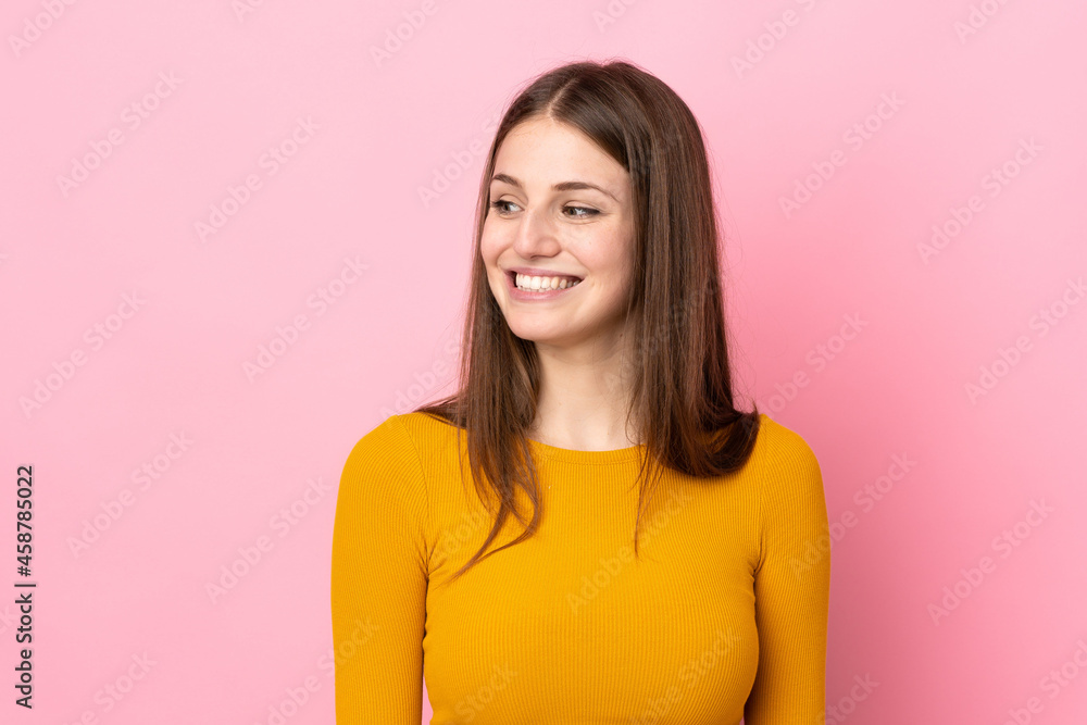 Young caucasian woman isolated on pink background looking to the side and smiling Young caucasian woman isolated on pink background looking to the side and smiling