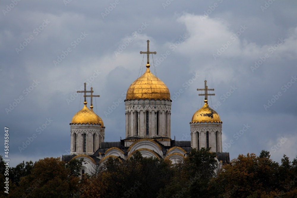 Golden dome of the Orthodox church against the background of gray autumn sky. Vladimir city.