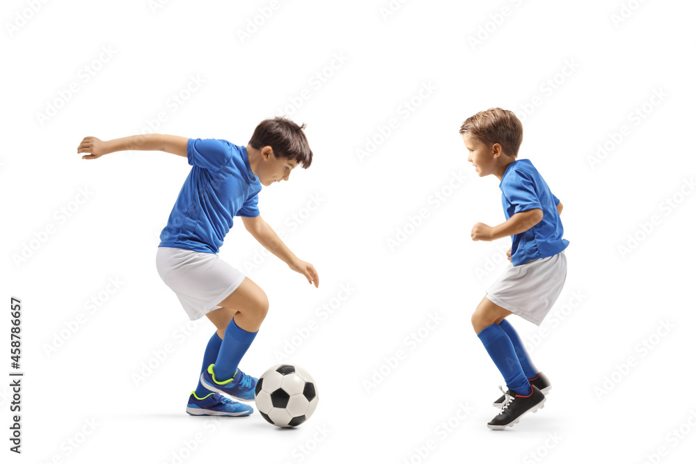 Two boys in football jersey playing with a ball