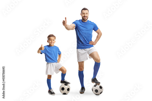 Man and boy with a soccer ball gesturing thumbs up © Ljupco Smokovski