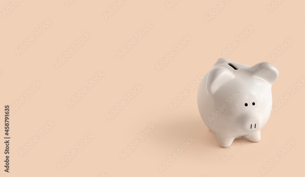 Piggy bank on orange background to right side Piggy bank on orange background to right side