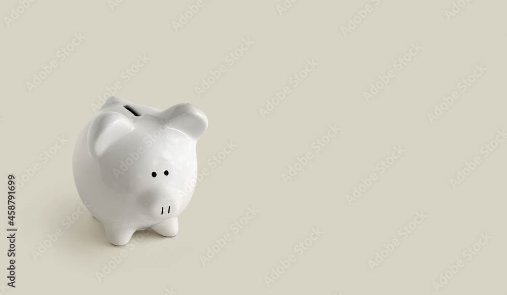 Piggy bank on green background to left side Piggy bank on green background to left side