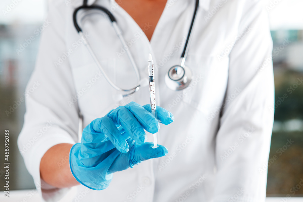 Doctor's hand holding syringe. Health care in hospital. Doctor's hand holding syringe. Health care in hospital.