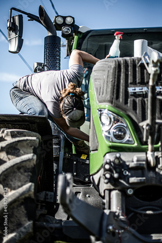 Wallpaper Mural Woman cleaning tractor on a sunny summer day Torontodigital.ca