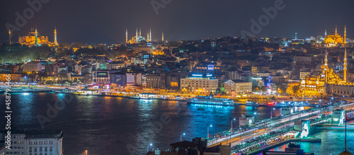 ISTANBUL - SEPTEMBER 17, 2014: City night panorama with Blue Mosque and Hagia Sophia on background. Istanbul is visited by more than 11 million people every year