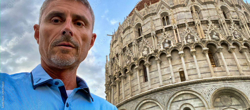 Happy man taking selfies in Square of Miracles, Pisa, Tuscany - Italy