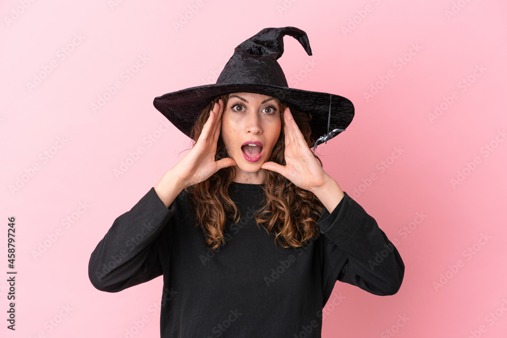Young caucasian woman celebrating halloween isolated on pink background with surprise expression