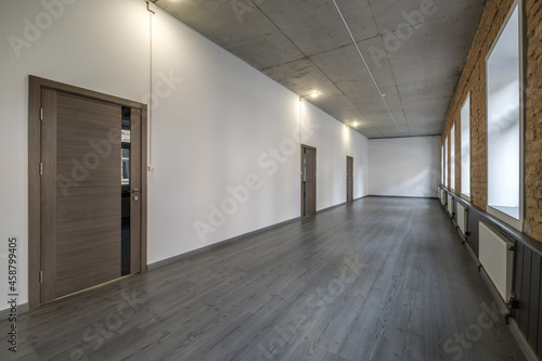 long white empty corridor in interior of entrance hall of modern apartments, office or clinic © hiv360