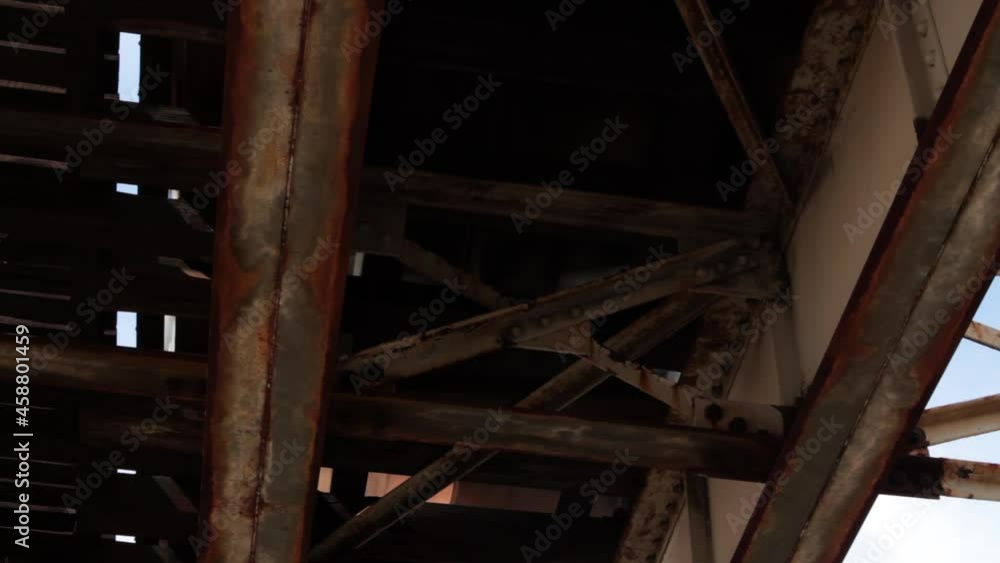Under rusted and dirty elevated train tracks in Chicago's south side. Close Train Passes overhead. Under rusted and dirty elevated train tracks in Chicago's south side. Close Train Passes overhead.