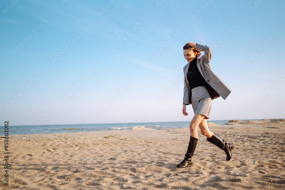 Fashion Model posing near the sea. Young woman resting in nature. People, lifestyle, relaxation and vacations concept. Fashion, style concept. Fashion Model posing near the sea. Young woman resting in nature. People, lifestyle, relaxation and vacations concept. Fashion, style concept.