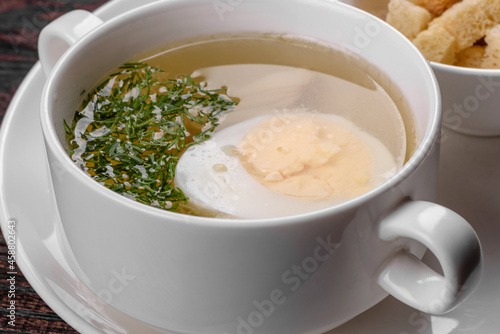 Asian noodle soup, ramen with chicken, vegetables and egg in white bowl