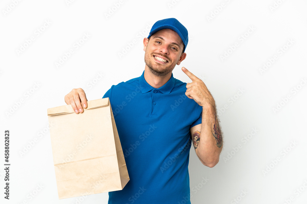 Brazilian taking a bag of takeaway food isolated on white background giving a thumbs up gesture