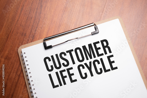 Customer Life Cycle text on white paper on the wood table