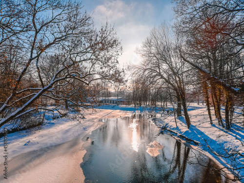 Snow covered landscape in city park in Braunschweig. Beautiful winter landscape on a sunny winter day