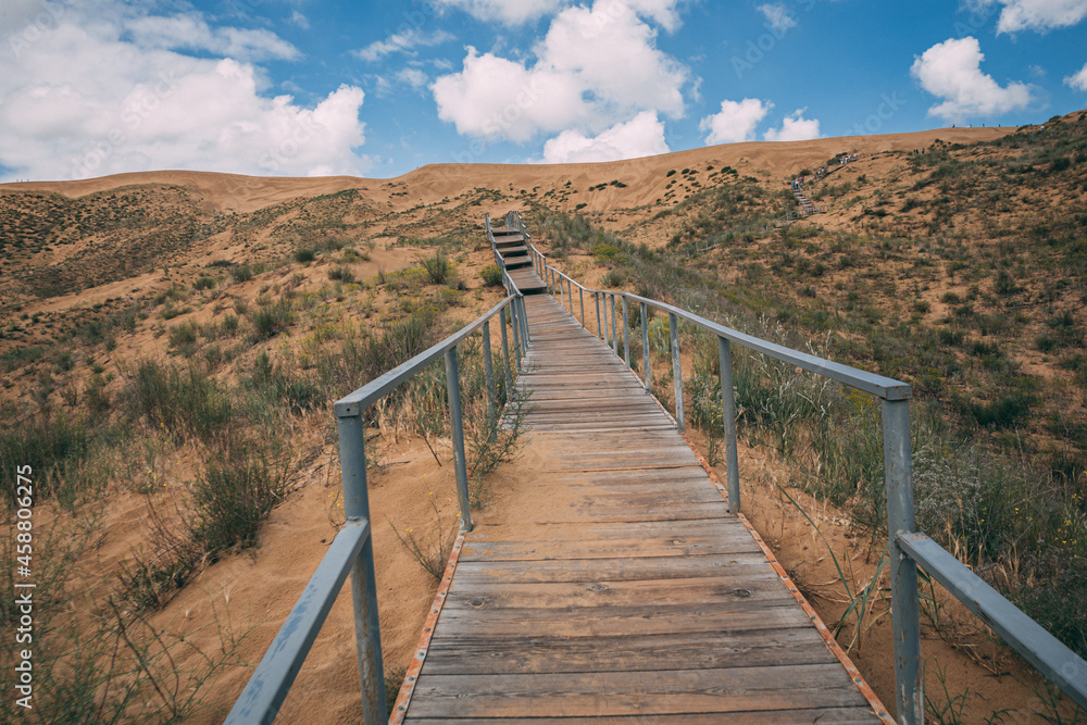 wooden walkway bridge under sand in dunes in Dagestan wooden walkway bridge under sand in dunes in Dagestan