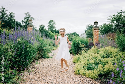 flower girl dancing at a wedding in a beautiful flower field