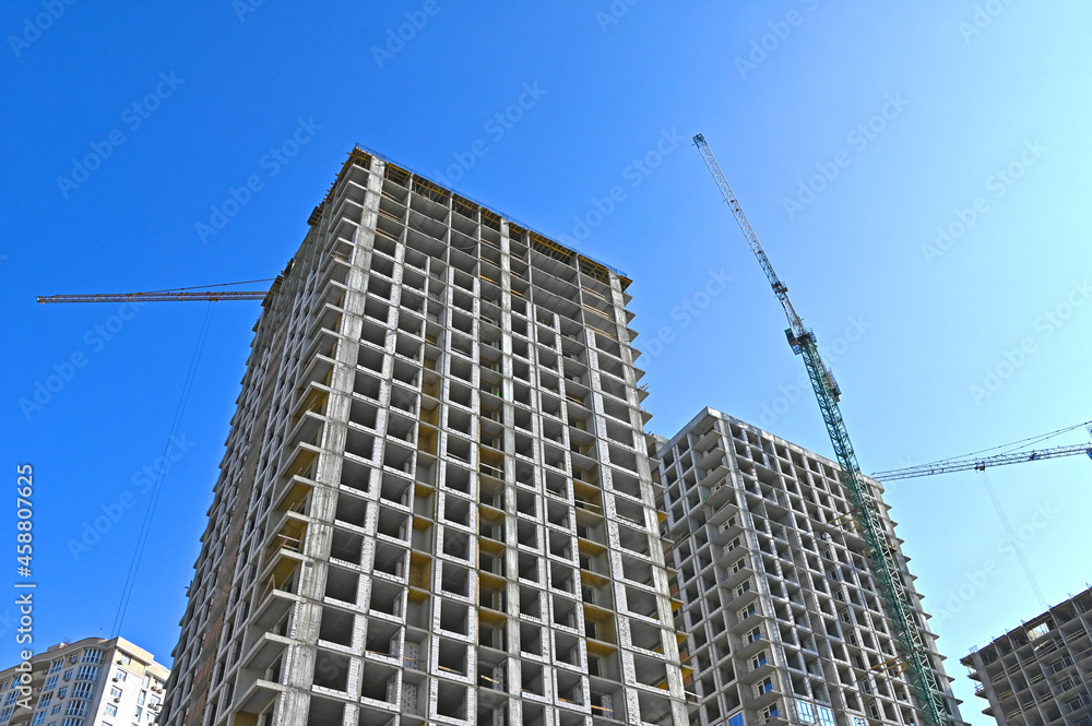 Crane and highrise construction site Crane and highrise construction site
