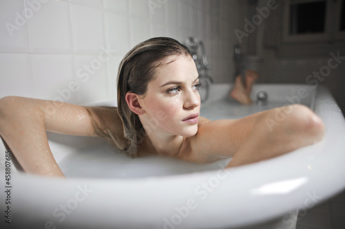 portrait of  ayoung beautiful woman in a bathtub photo