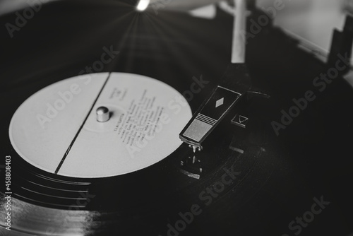 Old turntable. Retro record player with vinyl record. Turntable playing music with record. Turntable and record.