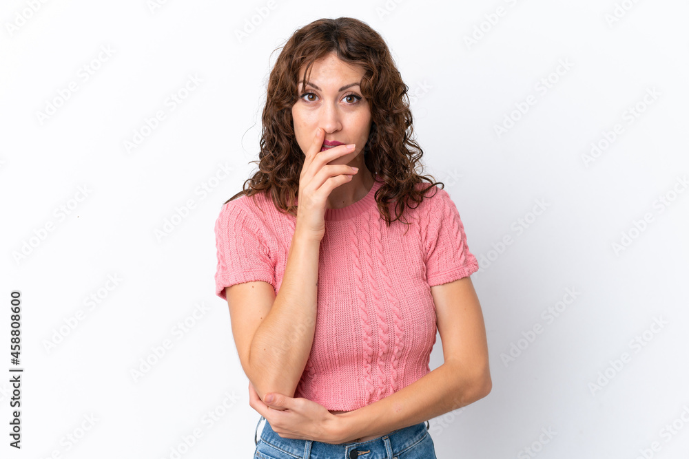 Young woman with curly hair isolated on white background surprised and shocked while looking right Young woman with curly hair isolated on white background surprised and shocked while looking right