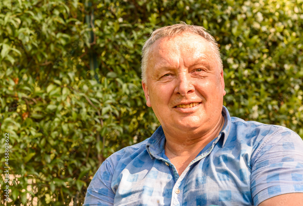 Portrait of happy mature man in the garden. Mature people lifestyle concept.