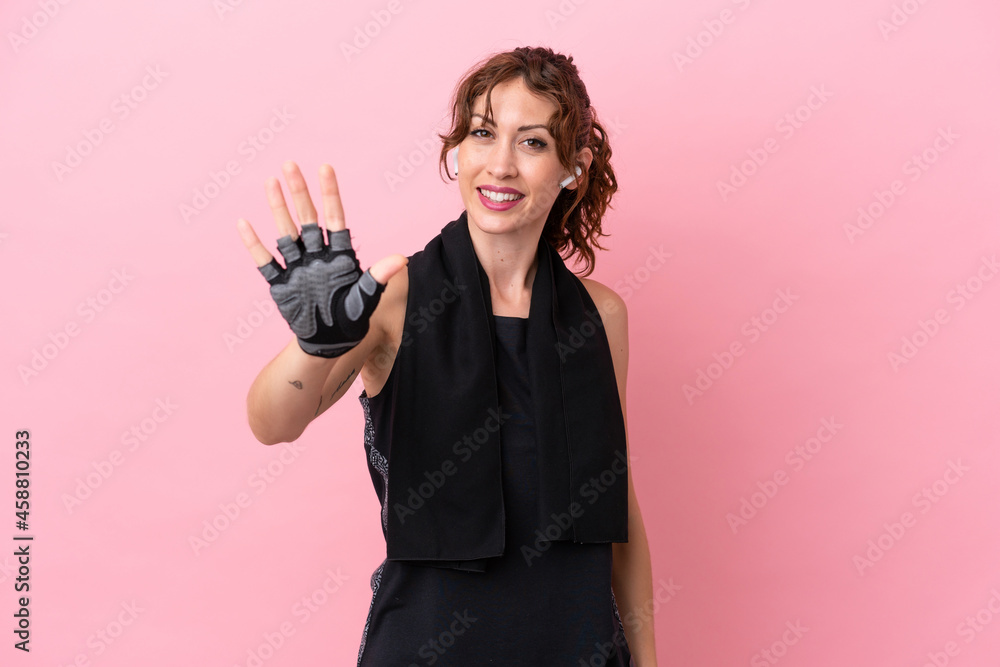 Sport sport woman with towel isolated on pink background counting five with fingers Sport sport woman with towel isolated on pink background counting five with fingers