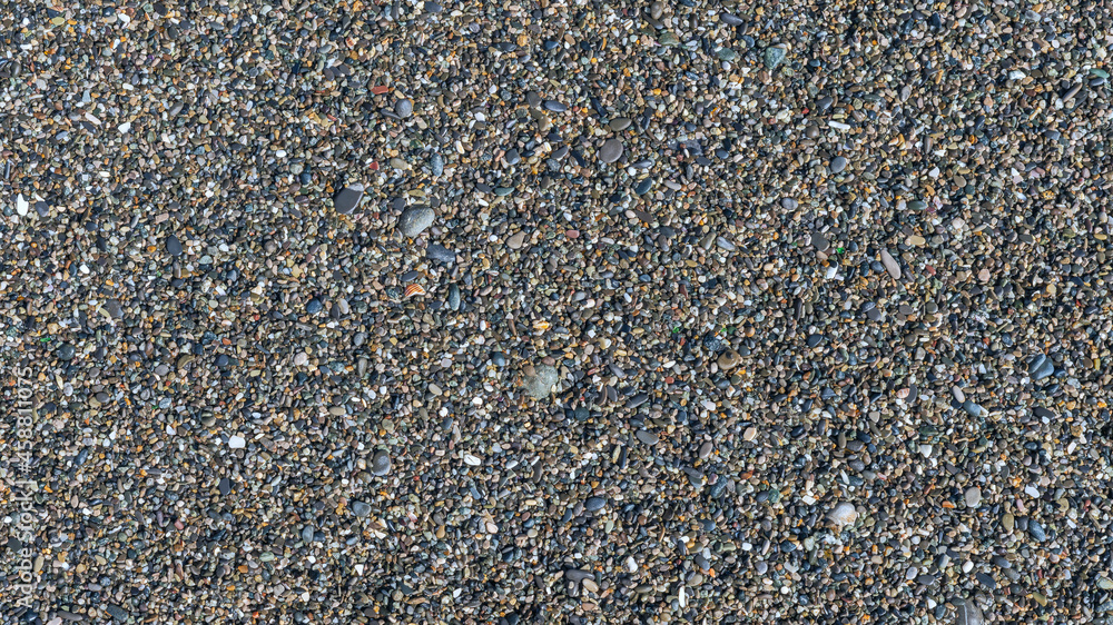 sea beach of small multi-colored pebbles as a natural background sea beach of small multi-colored pebbles as a natural background