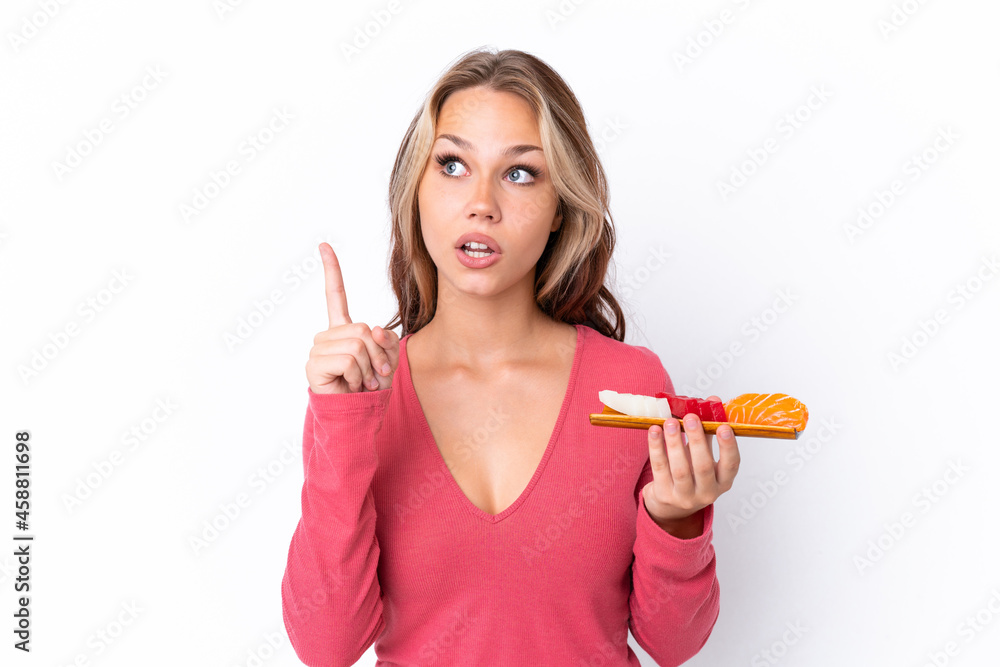 Young Russian girl holding sashimi isolated on white background thinking an idea pointing the finger up Young Russian girl holding sashimi isolated on white background thinking an idea pointing the finger up