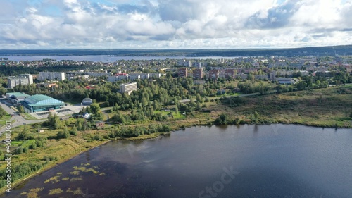 Aerial view of the city. Town. Houses. Lake. Clouds. City of Kondopoga drone shooting.