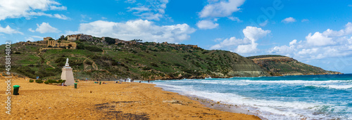 Photography The sandy Ramla Beach in Gozo, Malta with the Our Lady of Hope statue and the ab