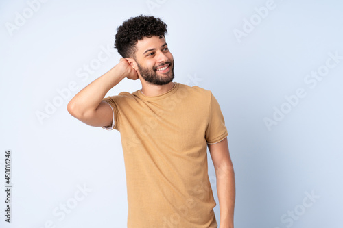 Young Moroccan man isolated on blue background thinking an idea