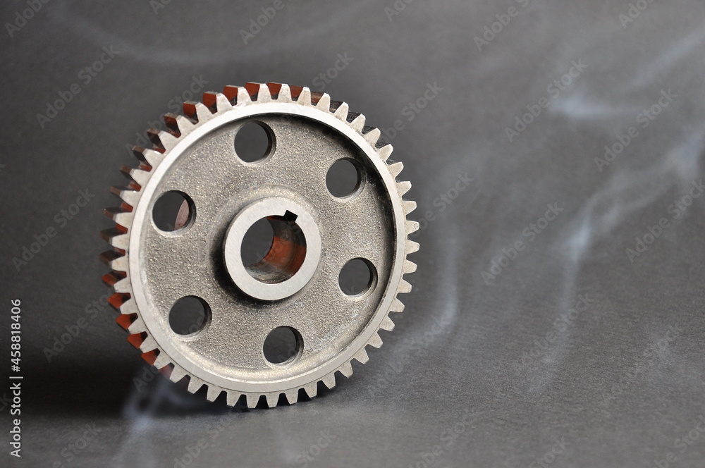 Engine parts. Metal cogwheel on a dark background. Spare parts. Engine parts. Metal cogwheel on a dark background. Spare parts.