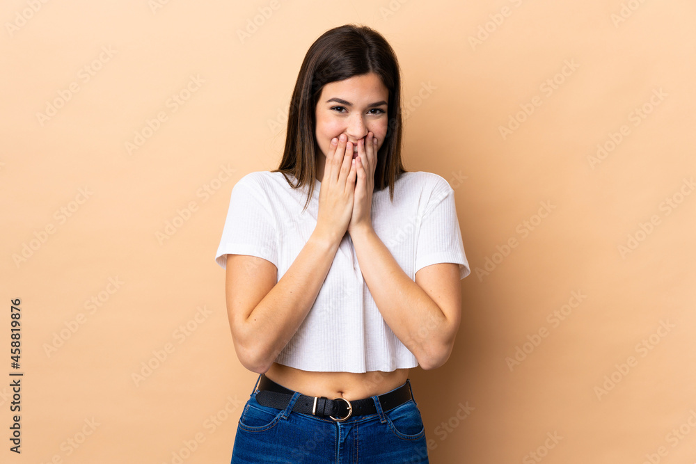 Teenager Brazilian girl over isolated background happy and smiling covering mouth with hands Teenager Brazilian girl over isolated background happy and smiling covering mouth with hands