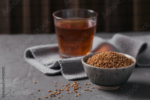 Bowl of fenugreek seeds and Egyptian fenugreek yellow tea or Methi Dana drink