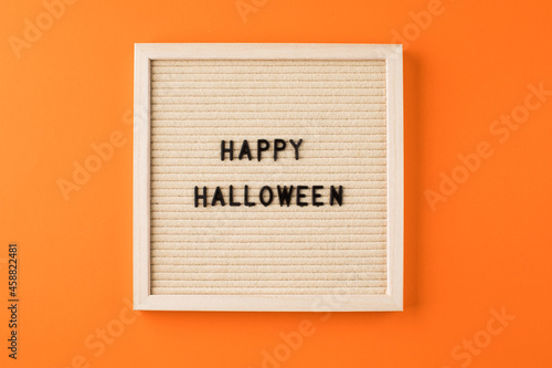 Greeting card with words Happy Halloween on orange color