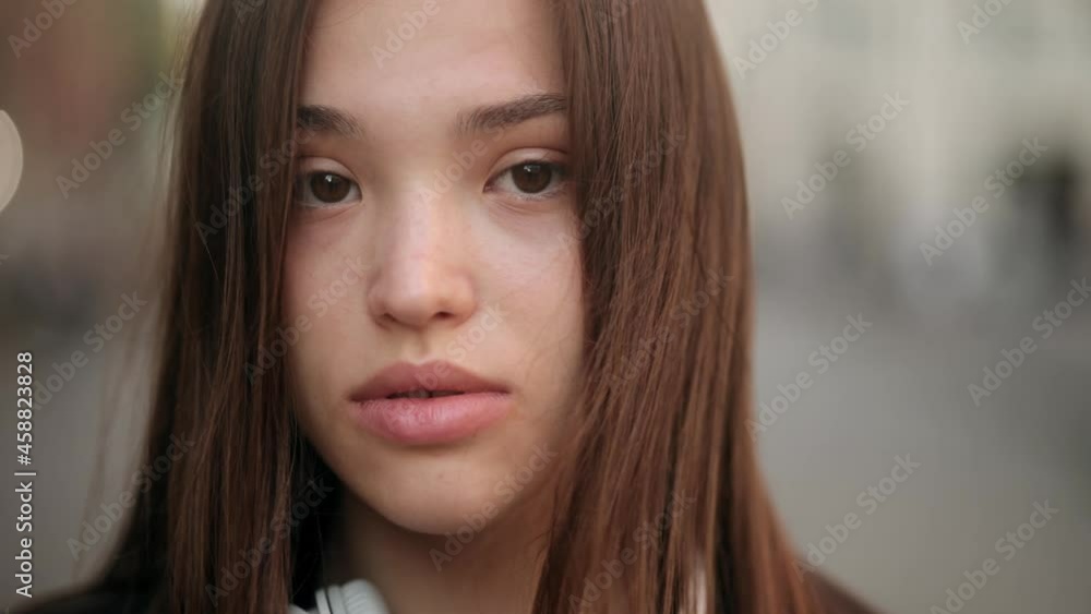 Portrait of gorgeous mixed race girl looking to camera. Joyful young brunette woman in headphones. Closeup face of beautiful sexy woman with long hair Portrait of gorgeous mixed race girl looking to camera. Joyful young brunette woman in headphones. Closeup face of beautiful sexy woman with long hair