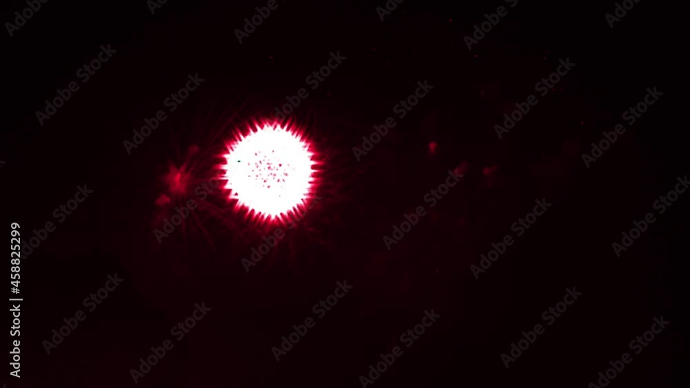 Blurred firework display on black night sky. Red fireworks in ball shape with star shaped sparks. Celebrating the holiday. Pyrotechnic show. Real time video. Blurred firework display on black night sky. Red fireworks in ball shape with star shaped sparks. Celebrating the holiday. Pyrotechnic show. Real time video.