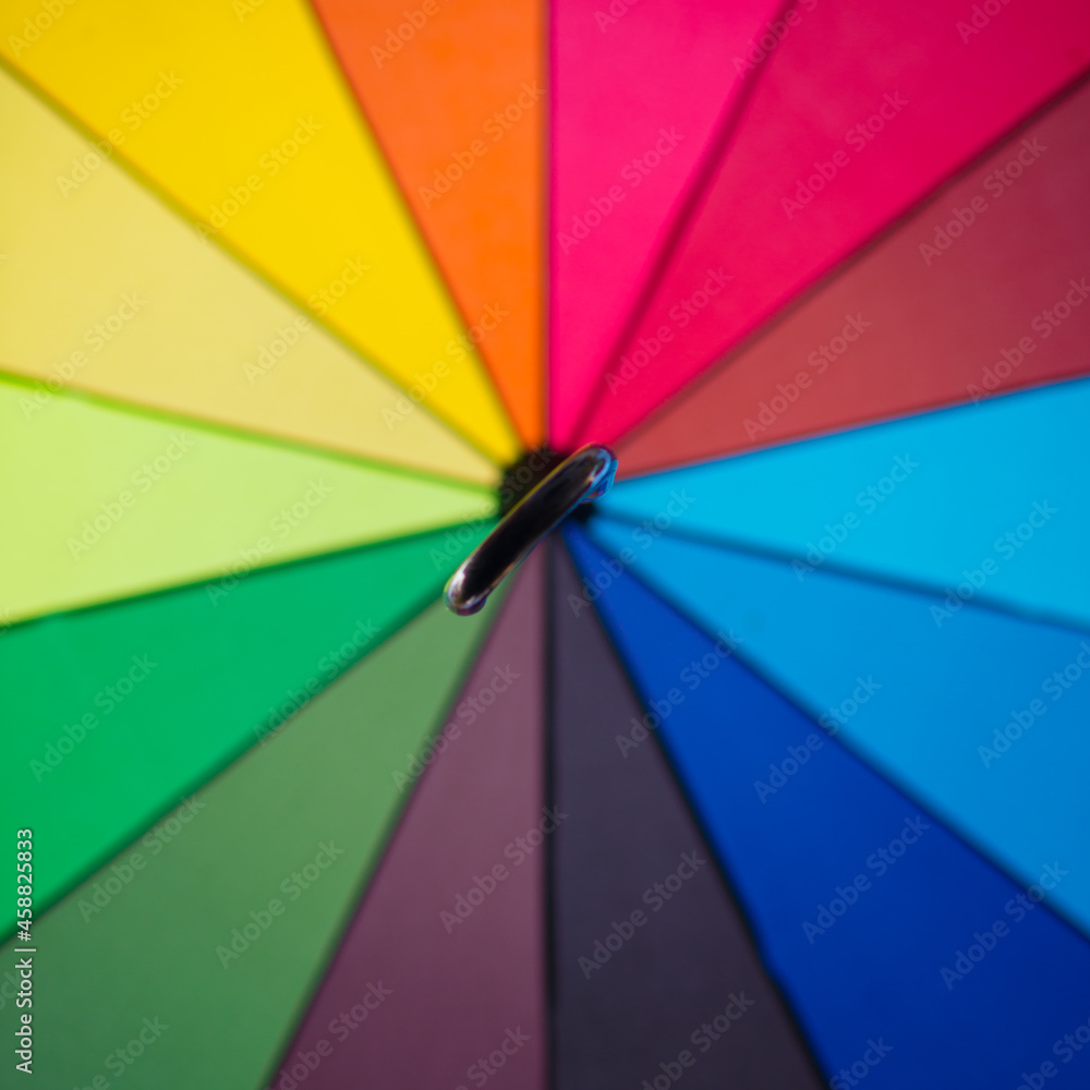 An open rainbow umbrella seen from below. An open rainbow umbrella seen from below.