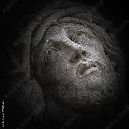 The Face of Jesus with the Crown of Thorns on the Head. Black background (concept religion)