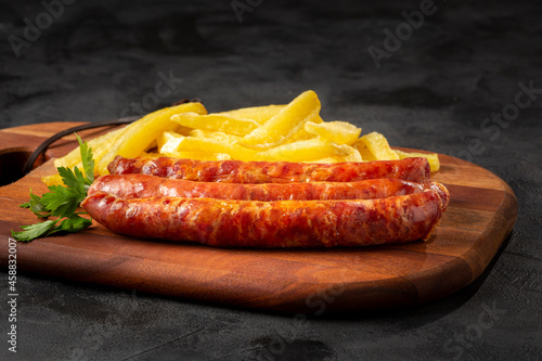 Grilled German sausage with french fries.