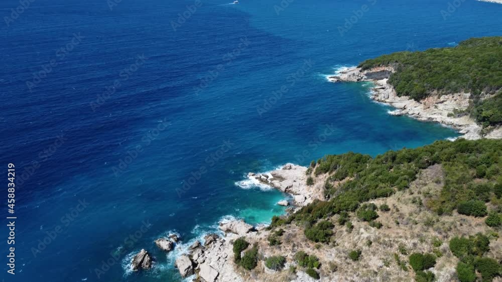 Aerial drone view of rocks, beaches and blue sea. Rocky shore seascape in summer. Crystal clean sea water. Coastline. Ionian sea near Ksamil in Albania. Aerial drone view of rocks, beaches and blue sea. Rocky shore seascape in summer. Crystal clean sea water. Coastline. Ionian sea near Ksamil in Albania.