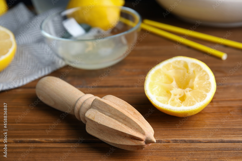 Citrus reamer and fresh lemons on wooden table Citrus reamer and fresh lemons on wooden table