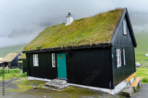 Close up view of the beautiful Black house with grass on the roof in the Faroe Islands  photo