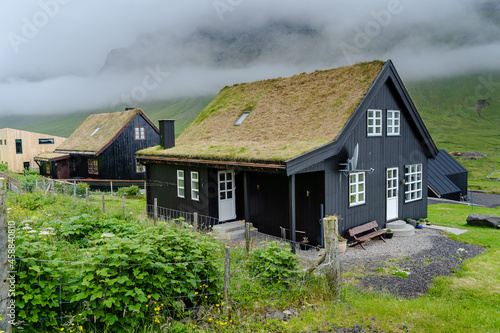 Close up view of the beautiful Black house with grass on the roof in the Faroe Islands  photo