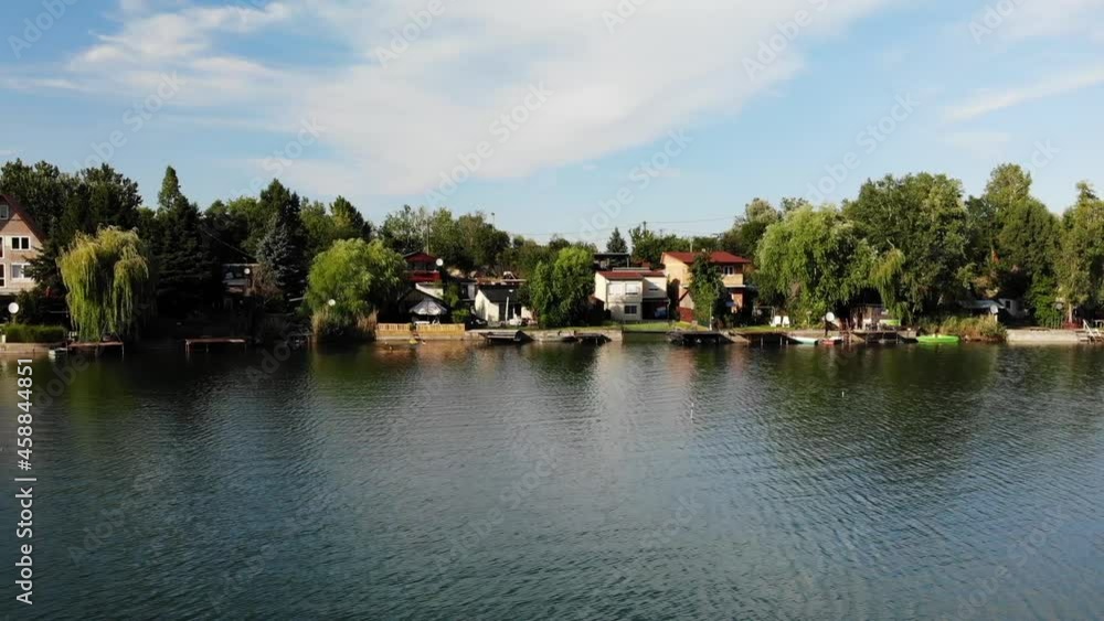 Kovicsos to, Csepel, Szigetszentmiklos. Aerial View, Scenic Lake Shore, Fishing Houses and Colorful Landscape on Sunny Summer Day, Sliding Drone Shot Kovicsos to, Csepel, Szigetszentmiklos. Aerial View, Scenic Lake Shore, Fishing Houses and Colorful Landscape on Sunny Summer Day, Sliding Drone Shot