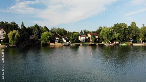 Kovicsos to, Csepel, Szigetszentmiklos. Aerial View, Scenic Lake Shore, Fishing Houses and Colorful Landscape on Sunny Summer Day, Sliding Drone Shot photo