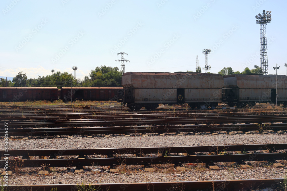 ancient train station with an abandoned train on the railway during the summer - transportation landscape ancient train station with an abandoned train on the railway during the summer - transportation landscape
