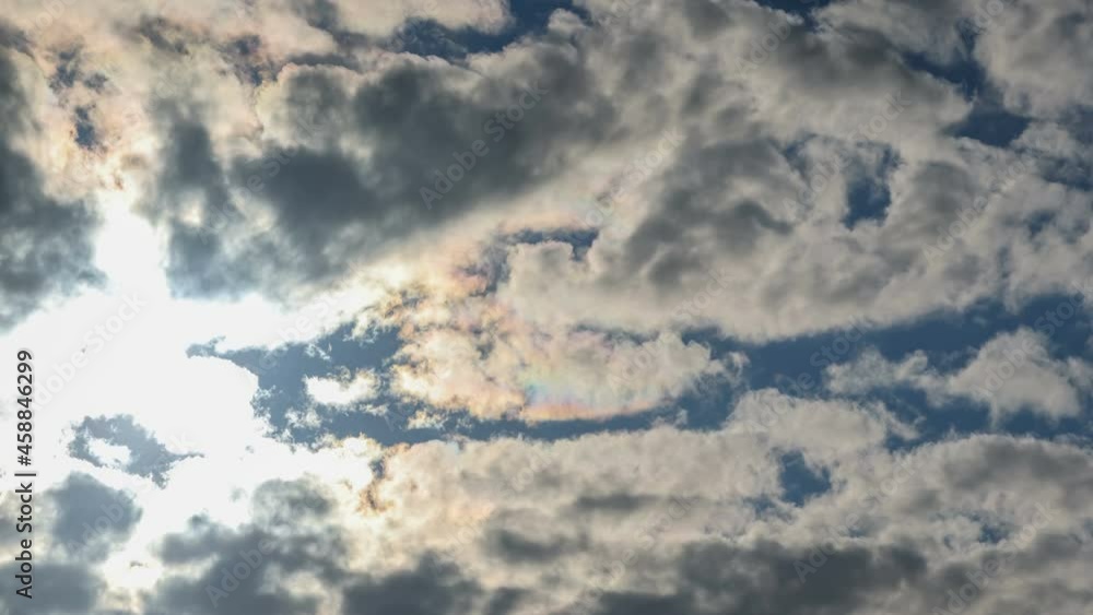 Blue sky heavy white clouds with glaring bright sun. Cumulus cloud cloudscape with a strong wind time-lapse. Nature weather. Cloud time lapse thick black clouds before storm. Puffy fluffy clouds. Blue sky heavy white clouds with glaring bright sun. Cumulus cloud cloudscape with a strong wind time-lapse. Nature weather. Cloud time lapse thick black clouds before storm. Puffy fluffy clouds.