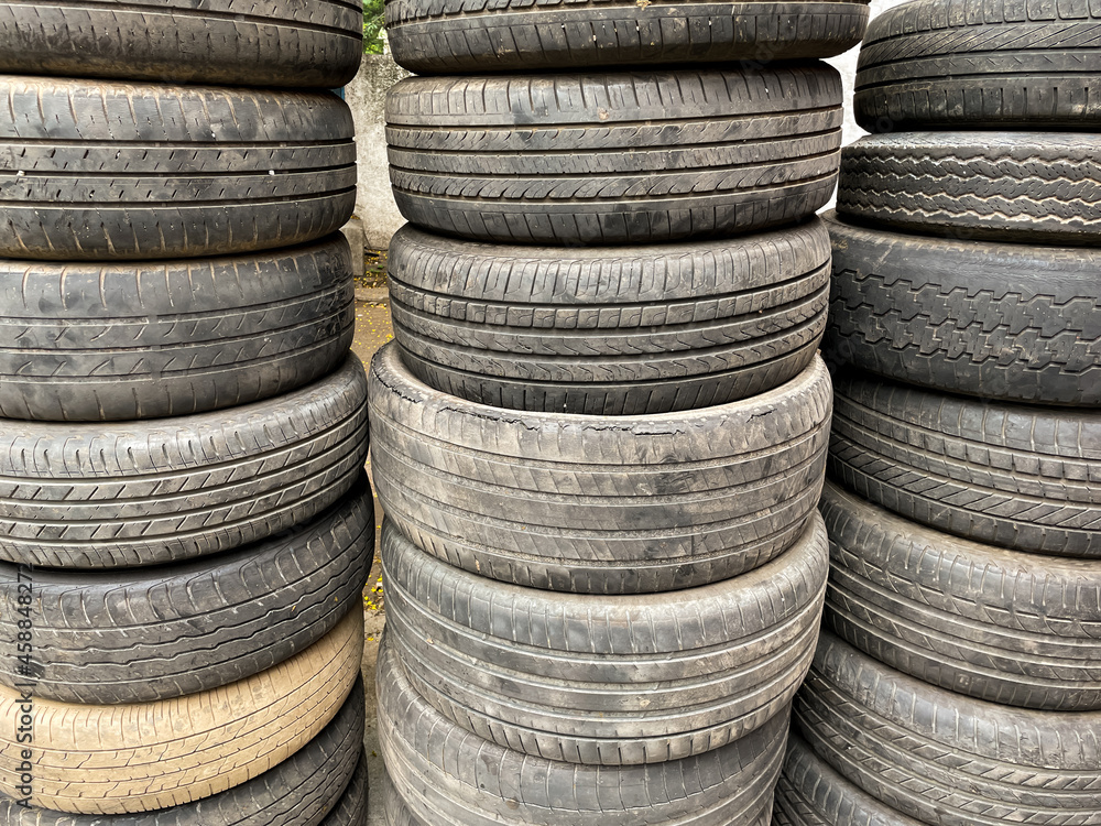 Used worn out Automobile tyres stacked one on top of each other
Used worn out Automobile tyres stacked one on top of each other