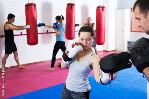 Young athlete girl training boxing sparring in gym